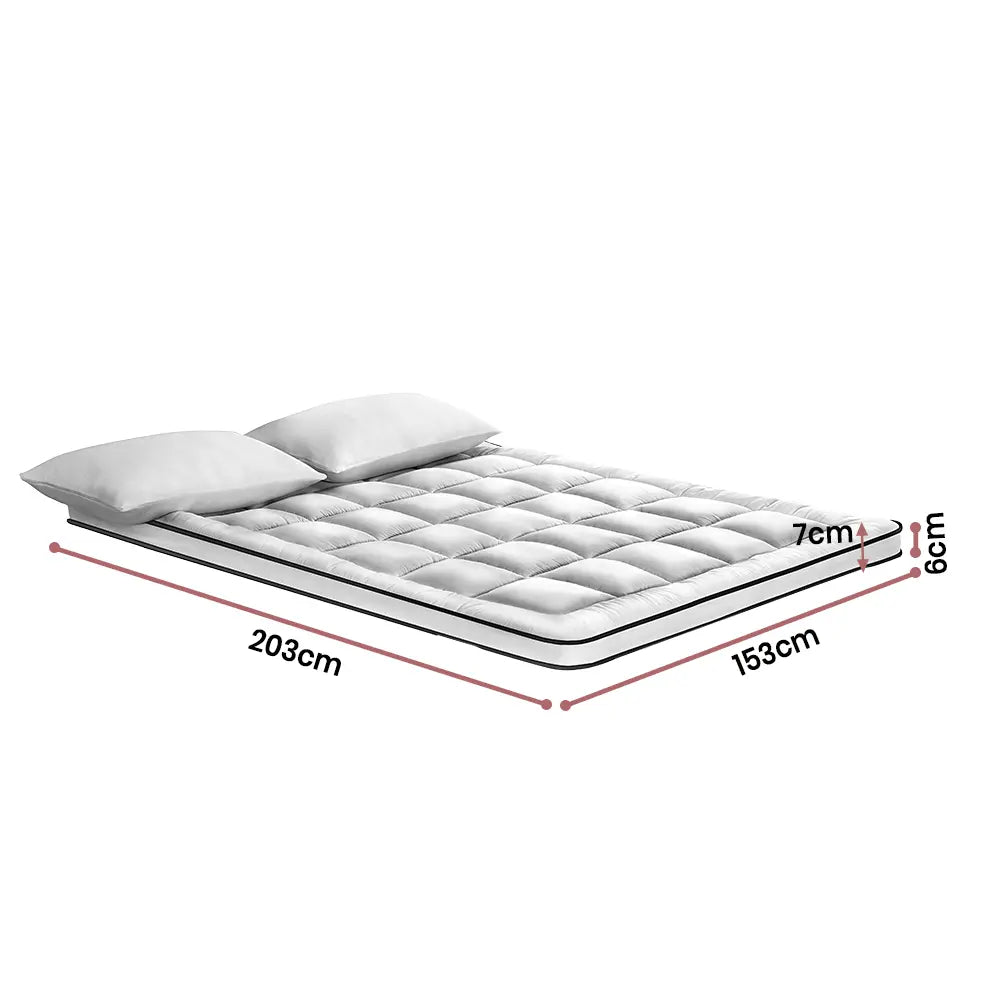 White Balmori mattress topper with dark grey edges on a queen-size bed